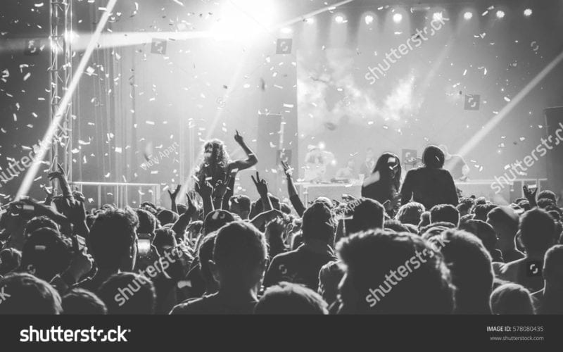 Shuttershock image of young people cheering at an concert